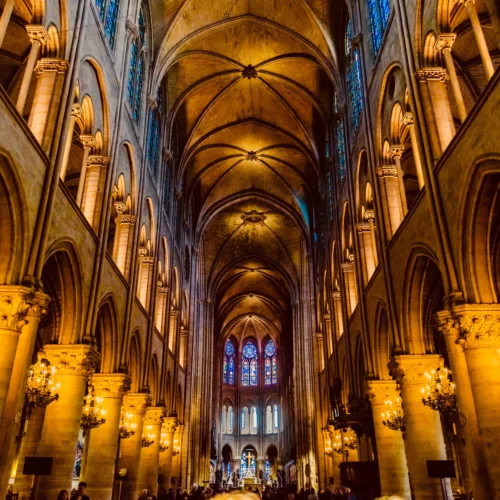 The interior of Notre Dame cathedral In Paris with lit candles during Notre Dame Guided Tour