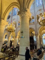 Wide shot of people inside cathedral during Notre-Dame tour in Paris