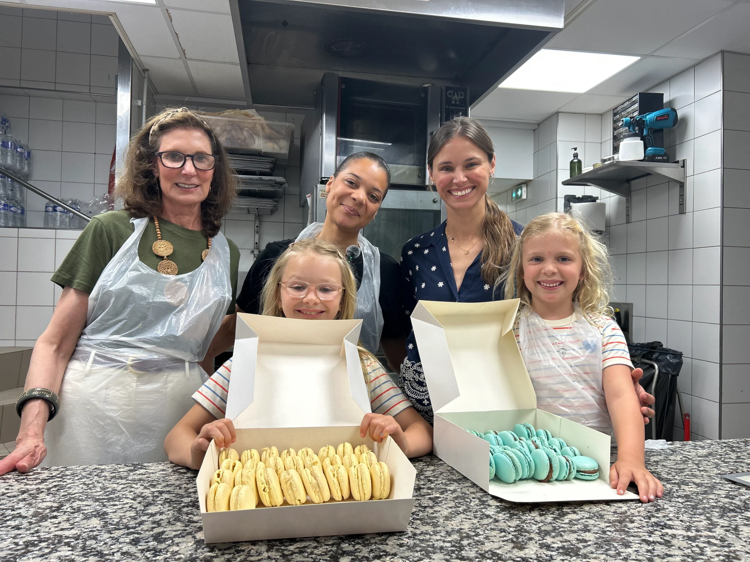 Kids showing off macarons they made in Paris