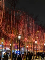 People walking through Champs Elysees with holiday lights on Paris Christmas tour