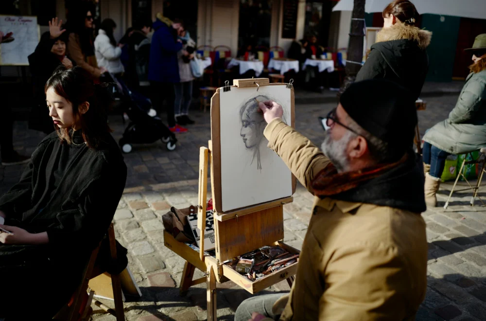 Artist sketching a woman in Montmartre Paris