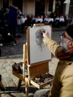 Artist sketching a woman in Montmartre Paris