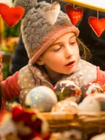 Mother and daughter looking at Christmas Market stall during private Christmas Lights guided tour