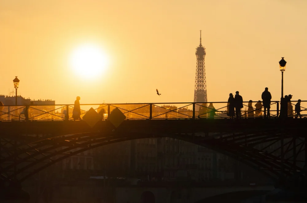 Silhouette of people near the River Seine during sunset