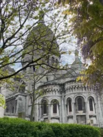View of Sacré-Cœur Basilica through trees during private tour in Paris