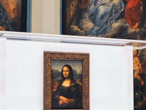 Mona Lisa at the Louvre with paintings in the background
