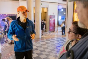 Close up of Tour Guide and guests listening inside Griffith Observatory