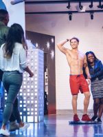 Visitors taking photo with Zac Efron Baywatch figure in Madame Tussauds