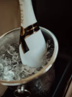 Bottle of champagne and glass in luxury car during private Los Angeles tour