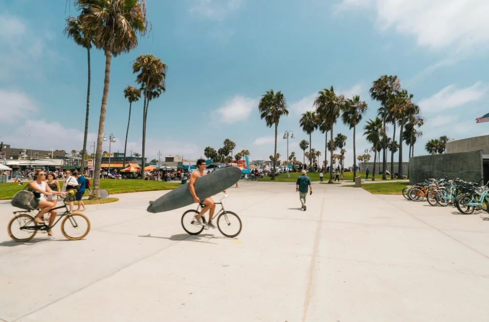 Man holding surfboard at Venice Beach