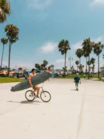 Man holding surfboard at Venice Beach