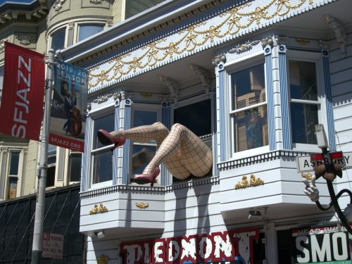 Giant legs in fishnet stockings sticking out of a Piedmont Boutique window in Haight Ashbury SF