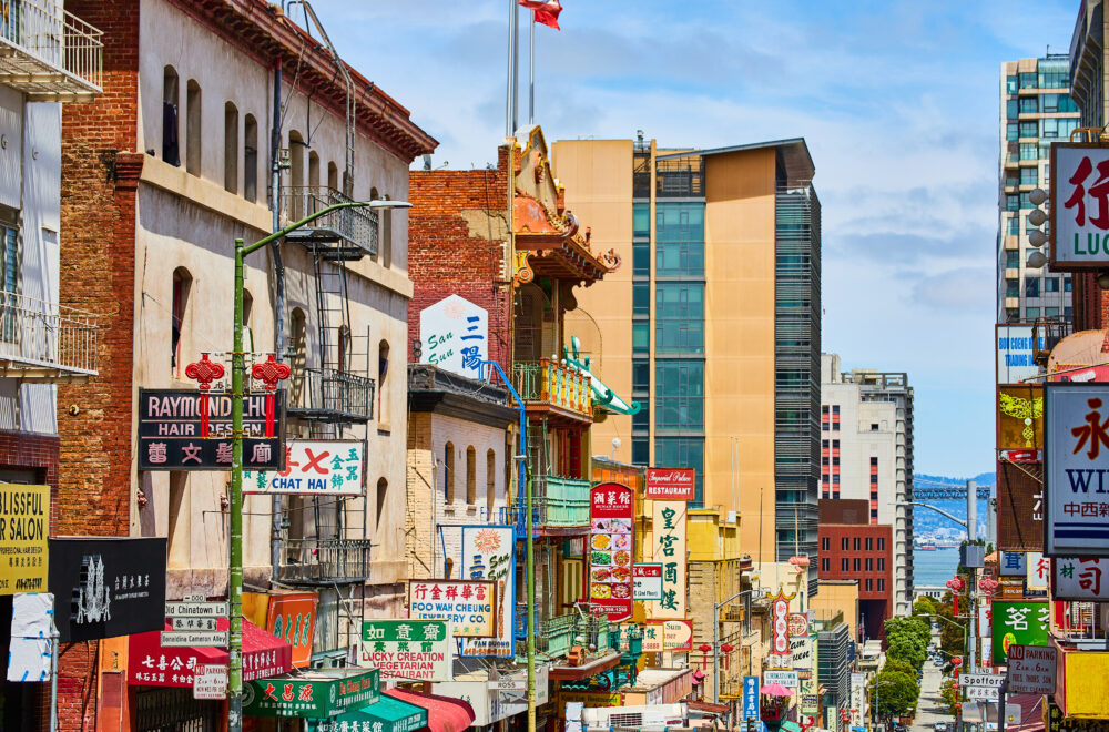 Chinatown street view of shop signs leading down street toward San Francisco Bay