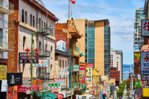 Chinatown street view of shop signs leading down street toward San Francisco Bay