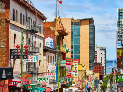 Chinatown street view of shop signs leading down street toward San Francisco Bay