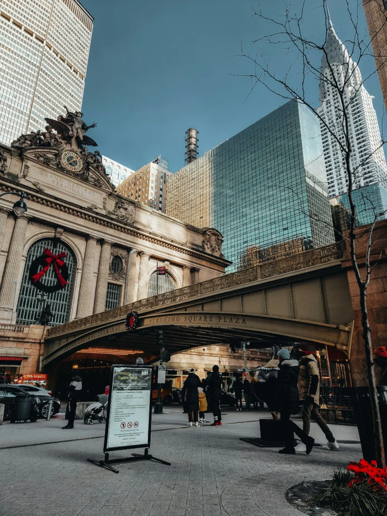 a group of people walking near Grand Central Terminal during winter