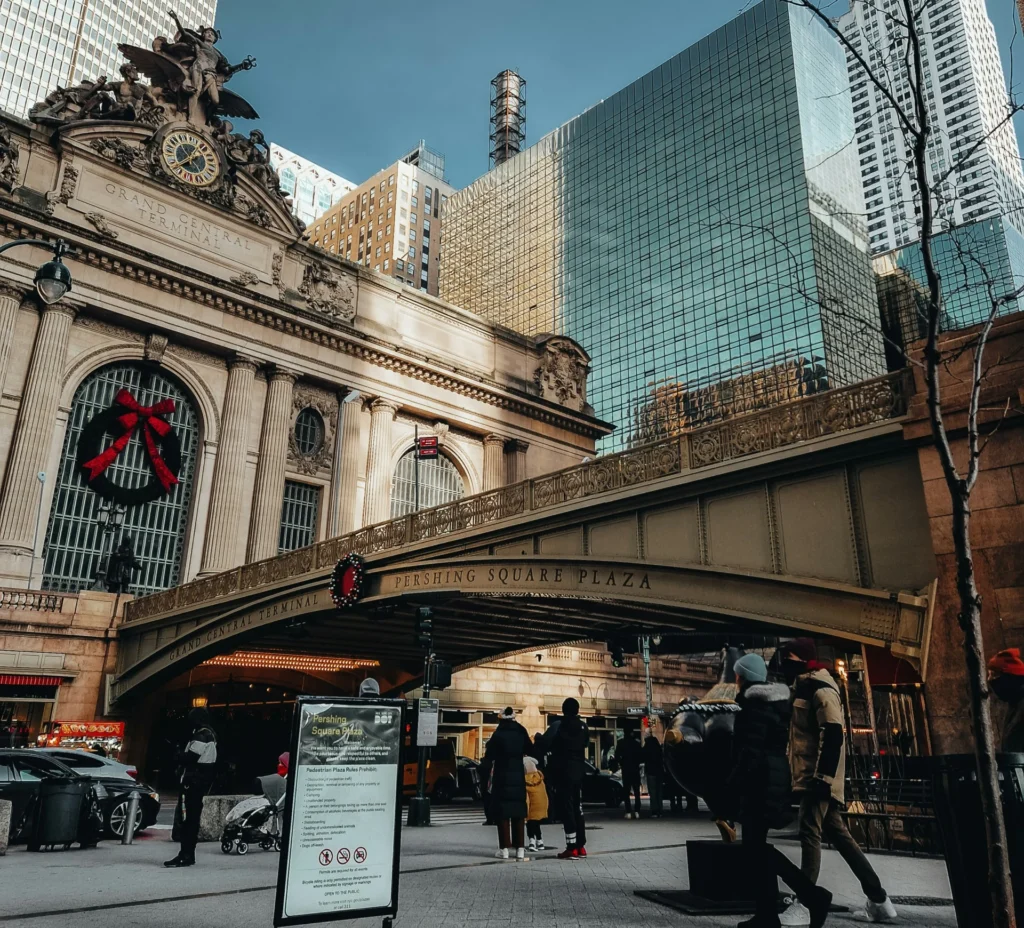 a group of people walking near Grand Central Terminal during winter