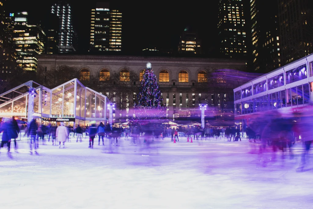 crowd on ice rink during night in Bryant Park NYC
