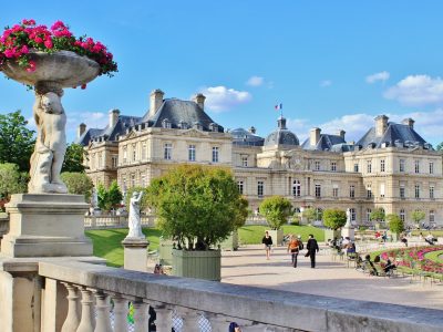 Luxembourg Gardens with cherubs holding flower pots in foreground and palace in the background