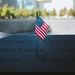 9/11 Memorial with American flag by fountain in NYC