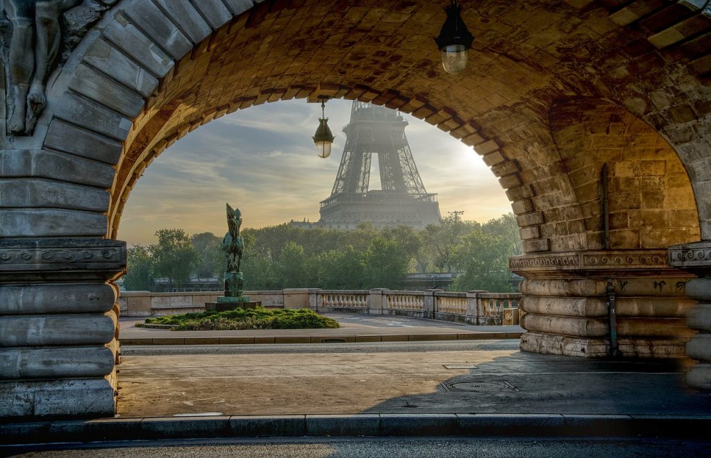 View of Eiffel Tower under arch alley way in Paris