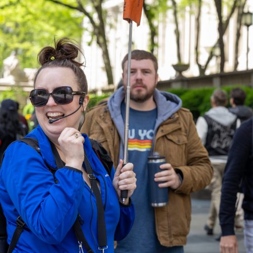 Tour guide smiling during NYC is a day tour