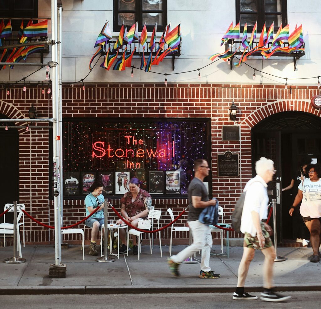People walking outside of The Stonewall Iron restaurant in NYC