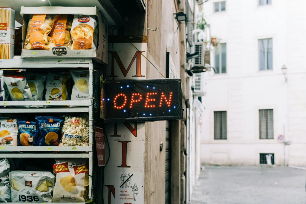 Neon sign saying Open outside a minimarket in Rome, Italy