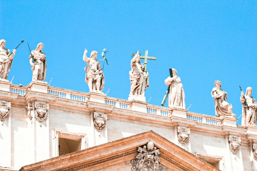 a group of statues on St Peter's Basilica