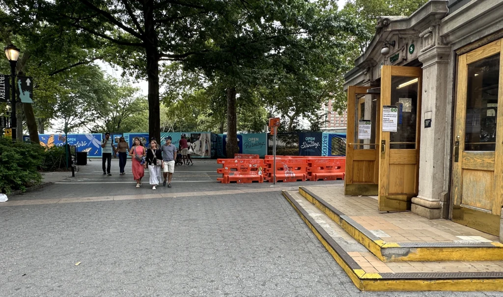 People crossing street near Castle Clinton