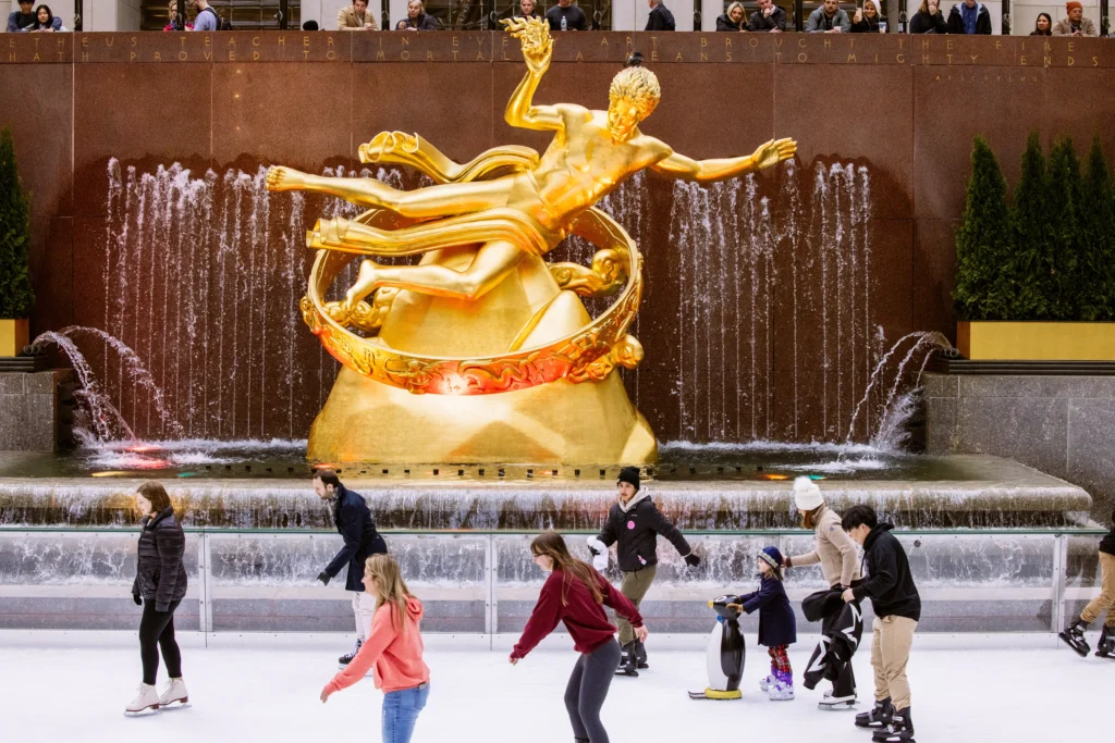 People ice skating near the Prometheus Statue in Rockefeller Plaza