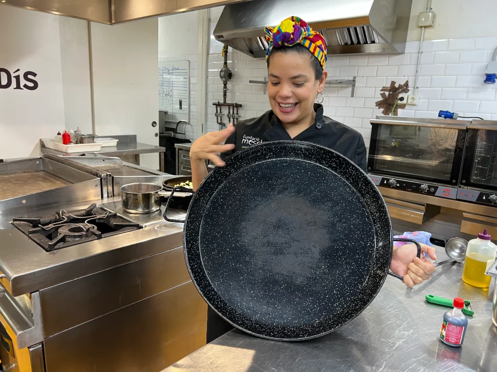 Chef posing with paella pan during Barcelona Cooking Class