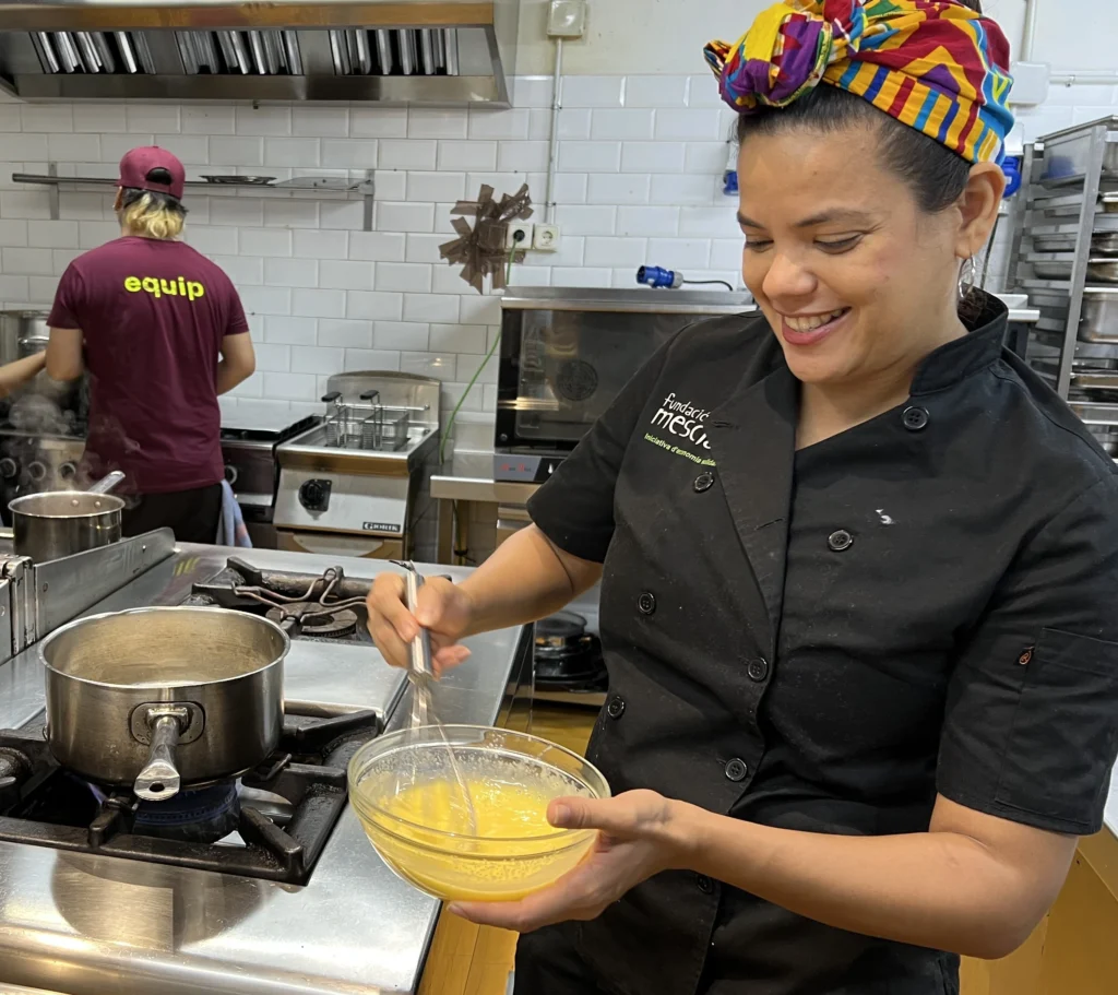 Chef whisking yolks during Barcelona Cooking Class