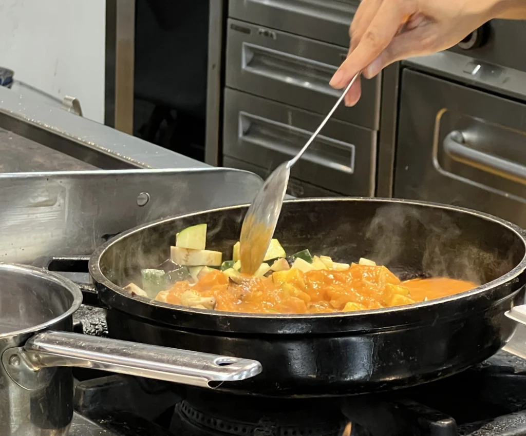 Close up of vegetables being cooked over the stove