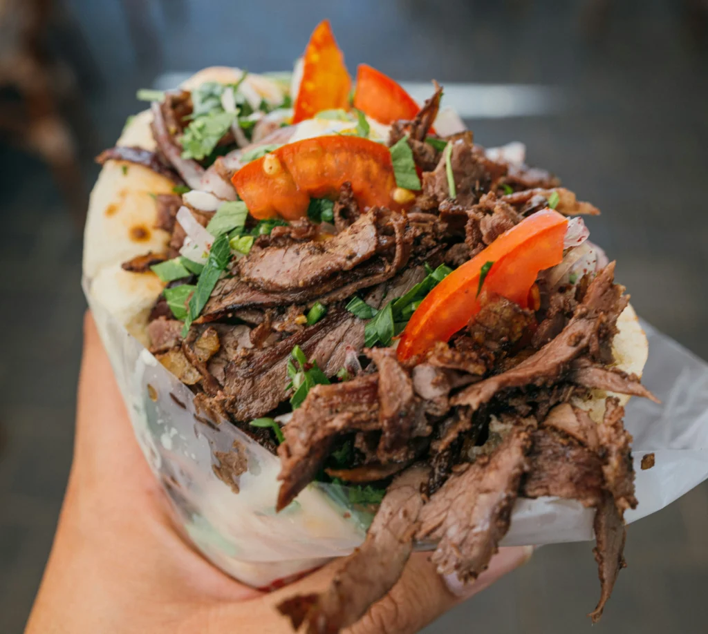 Person holding a kebab