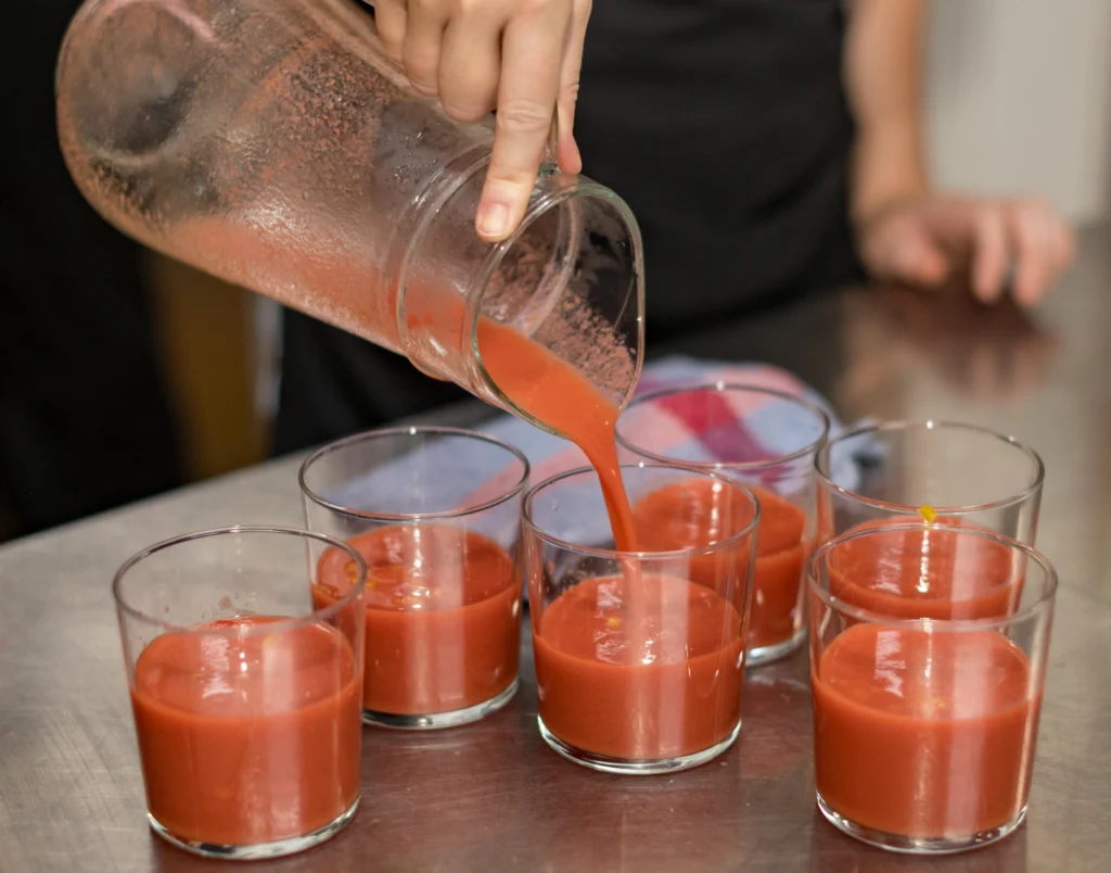 Pouring gazpacho during Barcelona Cooking Class
