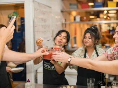Tour group cheersing drinks during cooking class in Barcelona